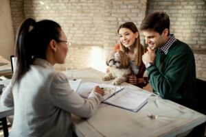 Mortgage broker working with a young couple