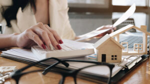 A real estate agent working with a calculator