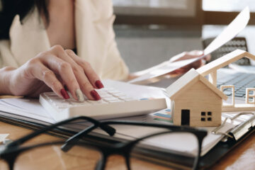 A real estate agent working with a calculator