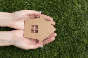 A wooden home over the green grass